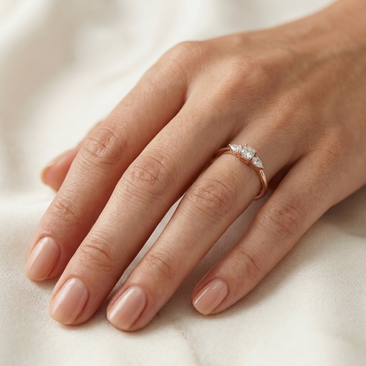 Cushion Cut Three Stone Engagement Ring with Pear Sides — lifestyle