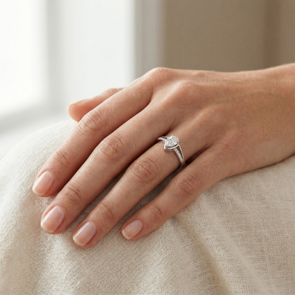 Pear Diamond Bezel Set Engagement Ring with Pavé Band — lifestyle