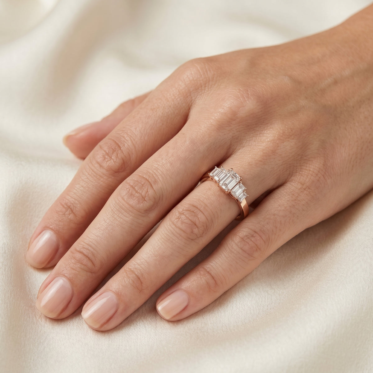 Emerald Cut Engagement Ring with Graduated Emerald Side Accents — lifestyle