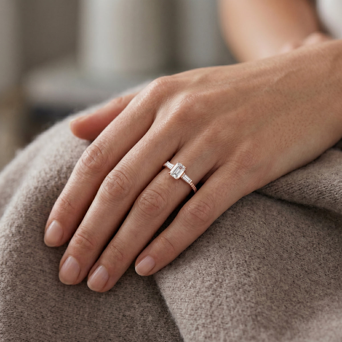 Emerald Cut Three Stone Engagement Ring with Baguette Sides and Pavé Band — lifestyle