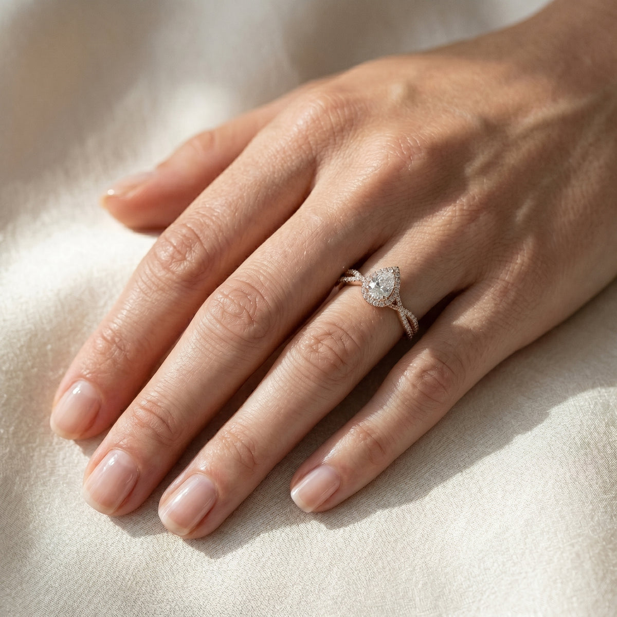Pear Diamond Halo Engagement Ring with Crossover Twisted Pavé Band — lifestyle