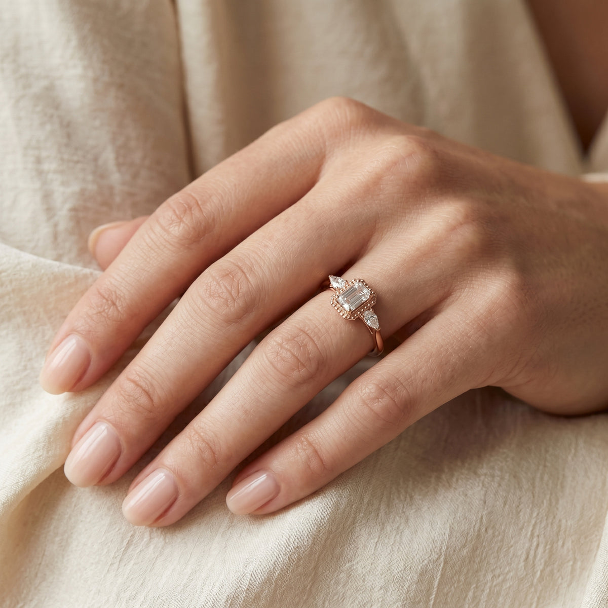 Emerald Cut Three Stone Halo Engagement Ring with Pear Sides