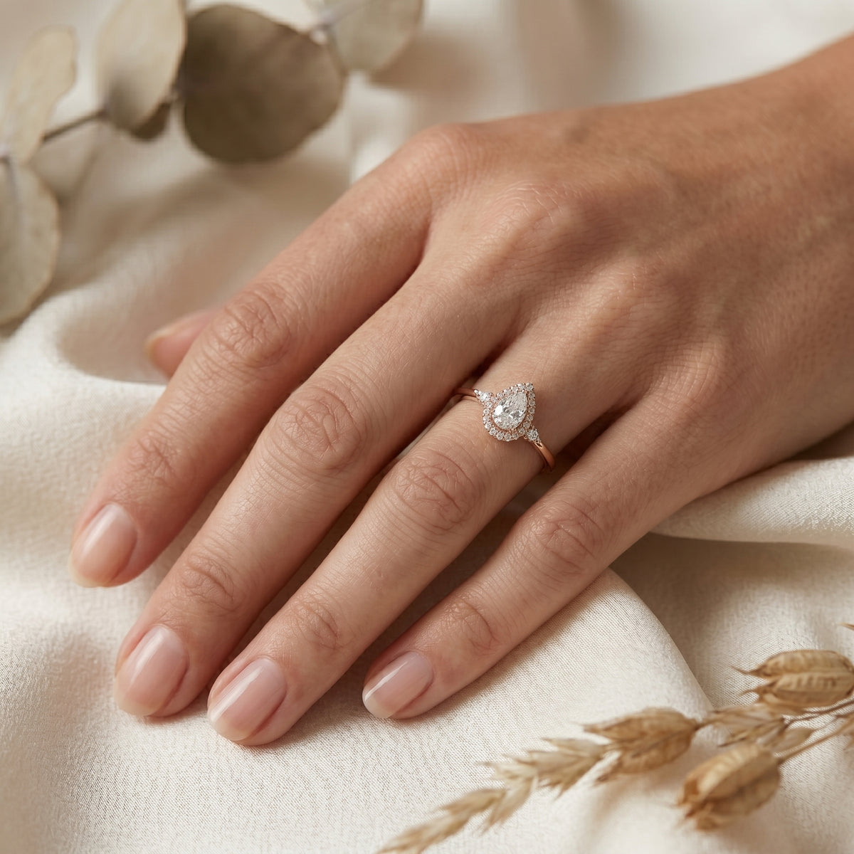 Pear Diamond Three Stone Halo Engagement Ring with Round Side Stones — lifestyle