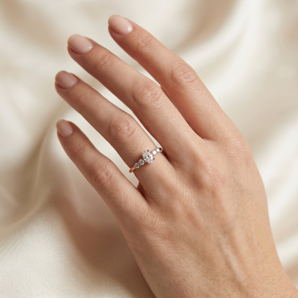 Oval Diamond Engagement Ring with Graduated Round Side Accents — lifestyle