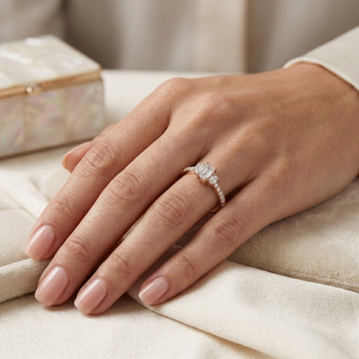 Emerald Cut Three Stone Engagement Ring with Oval Sides and Pavé Band — lifestyle