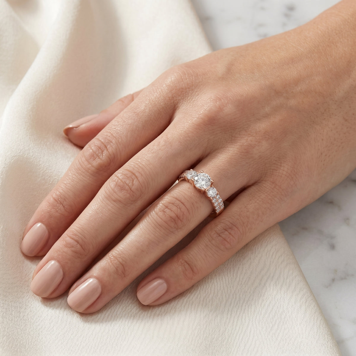 Cushion Cut Three Stone Engagement Ring with Round Sides and Pavé Band — lifestyle