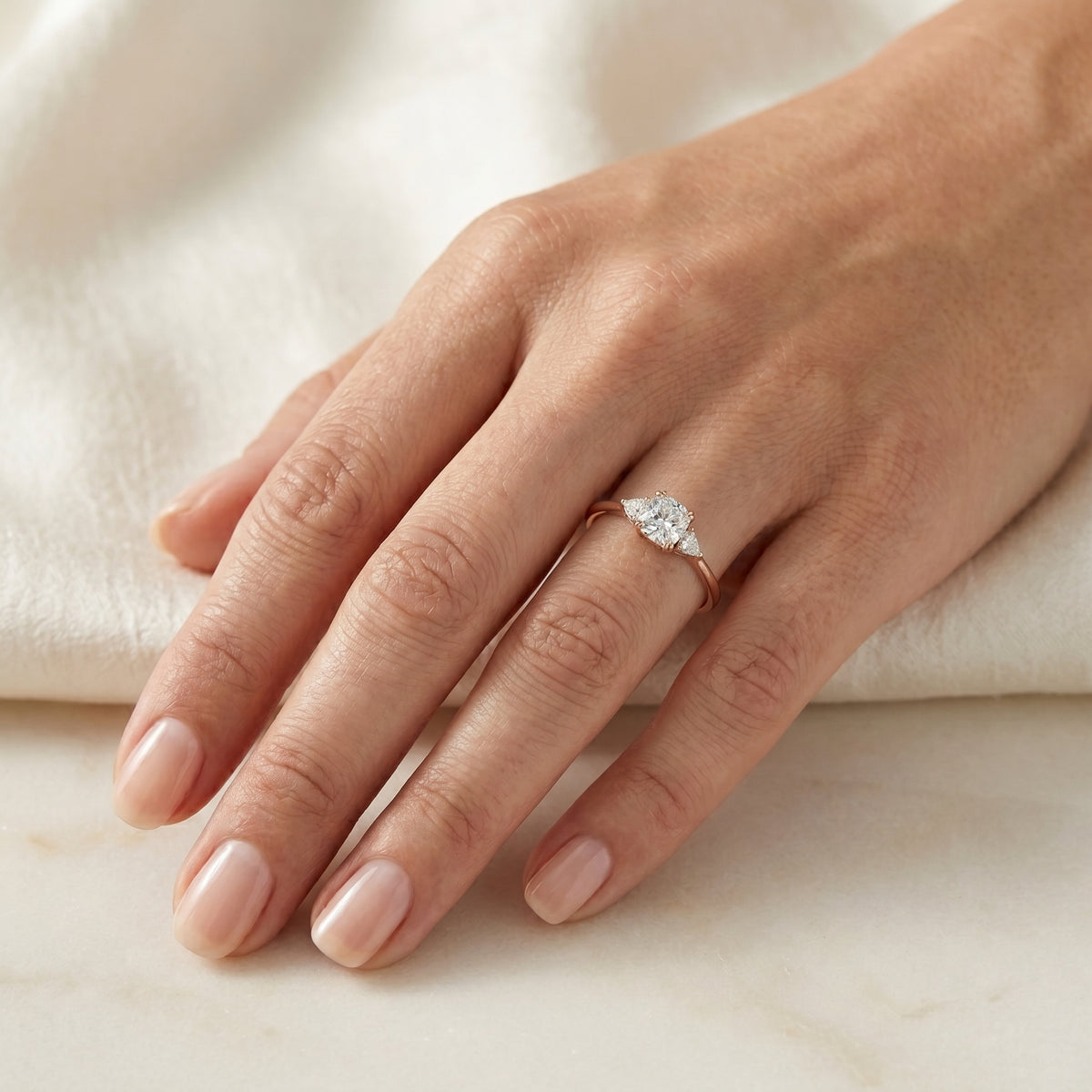 Cushion Cut Three Stone Engagement Ring with Trilliant Sides — lifestyle