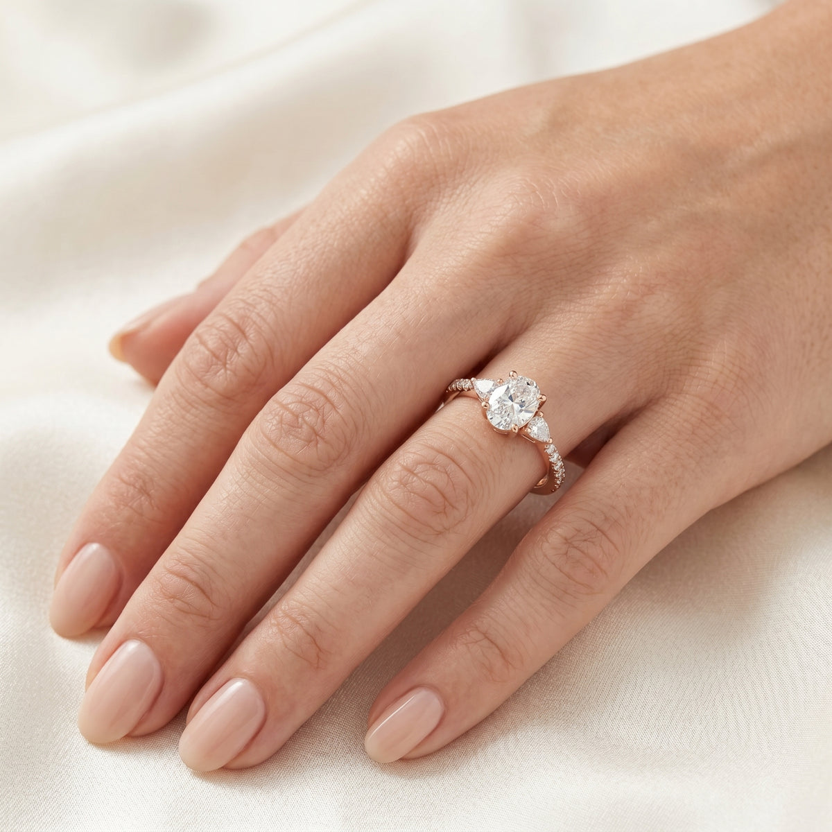 Oval Diamond Three Stone Engagement Ring with Trilliant Sides and Pavé Band — lifestyle