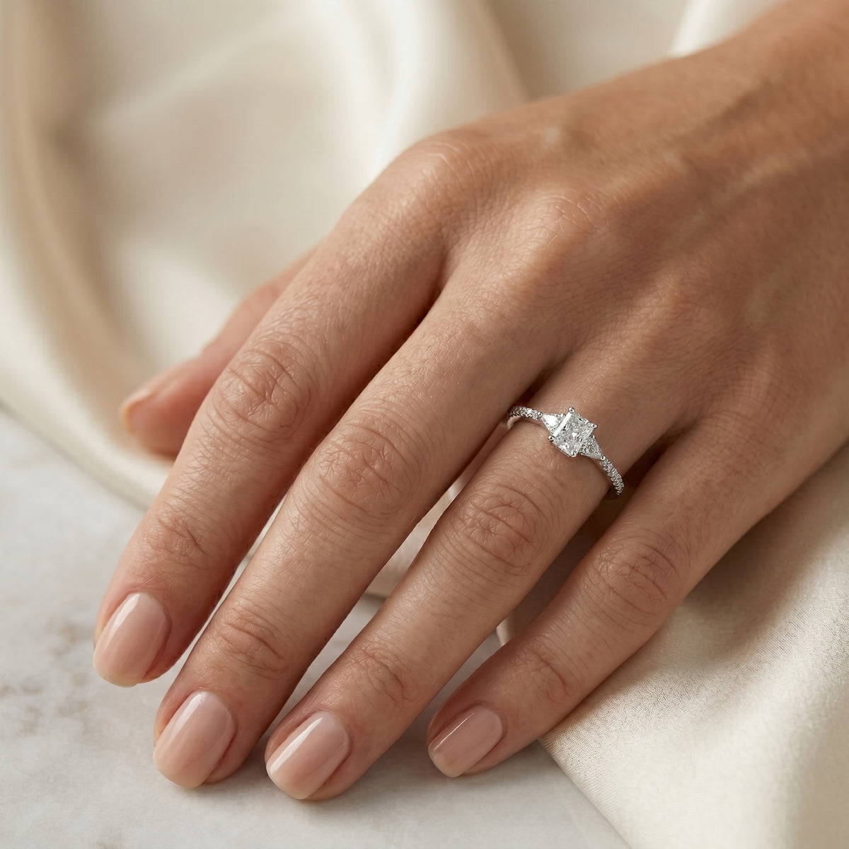 Radiant Cut Three Stone Engagement Ring with Trilliant Sides and Pavé Band — lifestyle