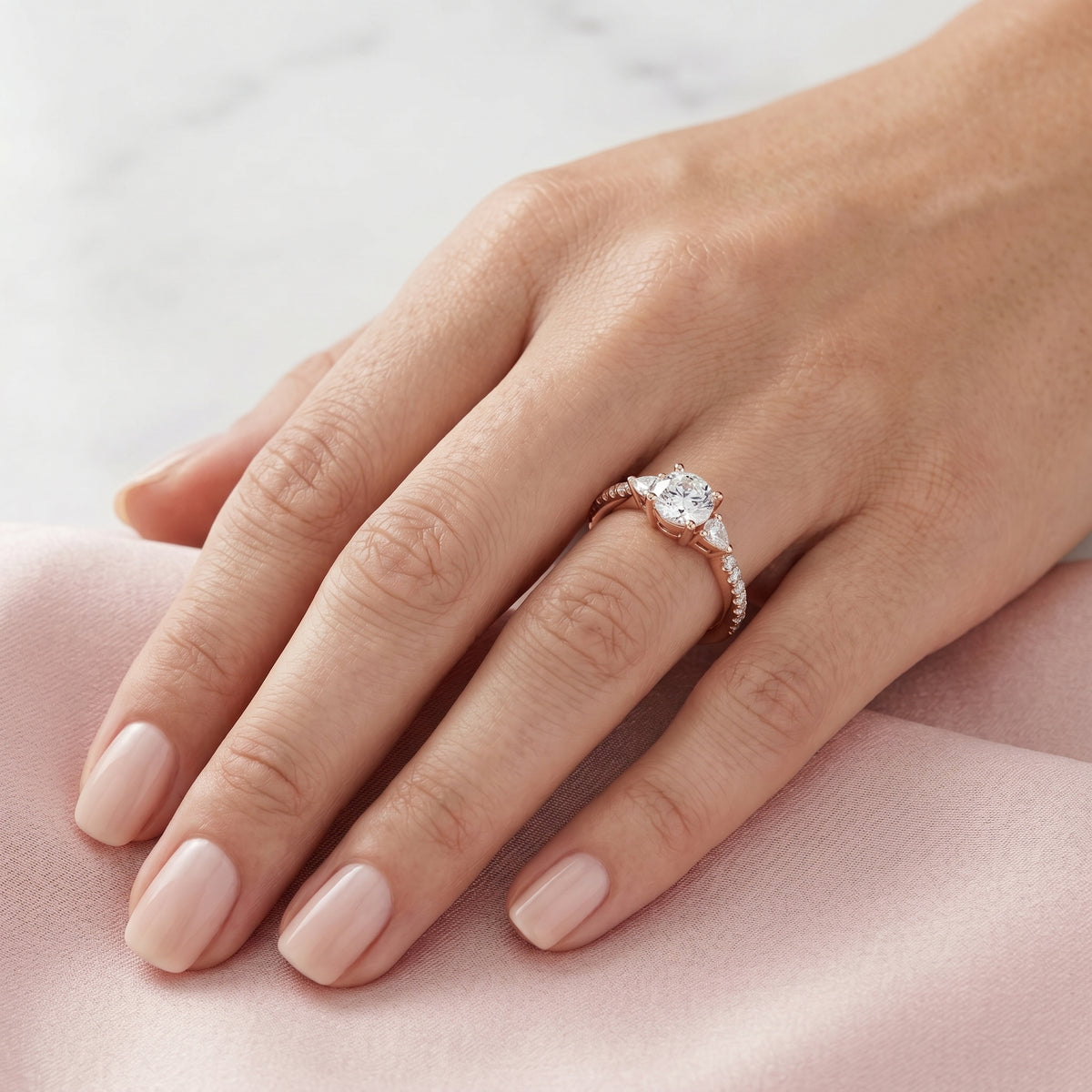 Round Diamond Three Stone Engagement Ring with Trilliant Sides and Pavé Band