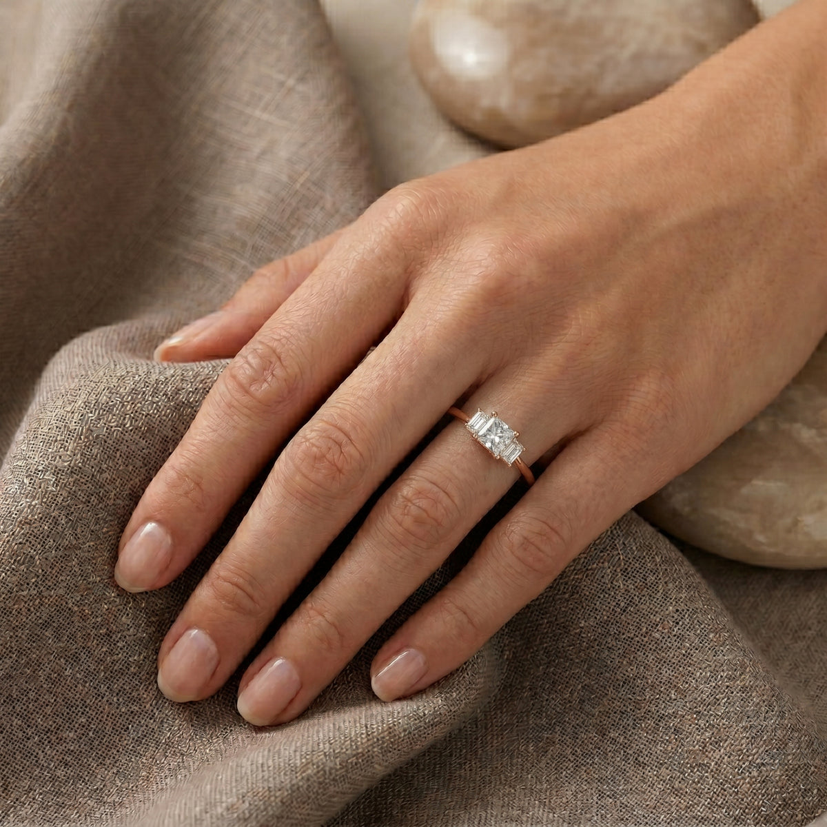 Princess Cut Three Stone Engagement Ring with Tapered Baguette Sides — lifestyle