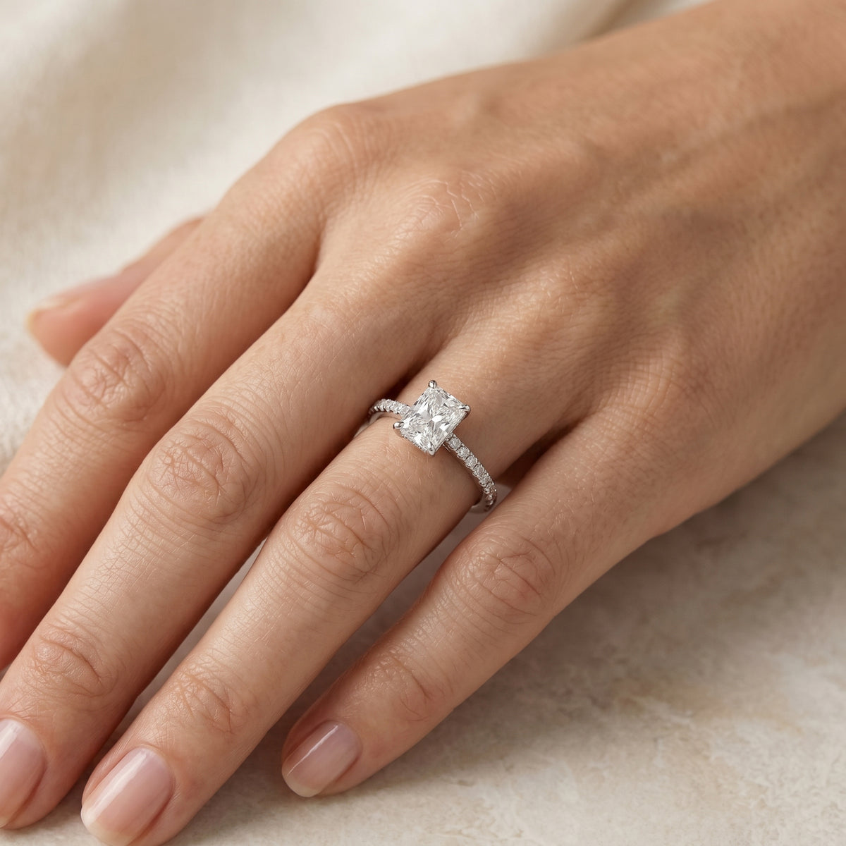 Radiant Cut Three Stone Engagement Ring with Tapered Baguette Sides and Pavé Band