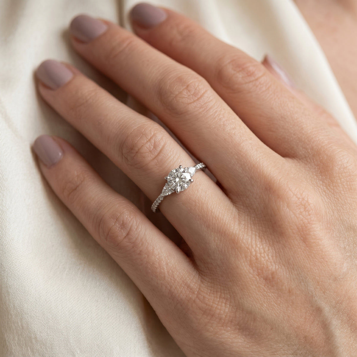 Round Diamond Three Stone Engagement Ring with Trilliant Sides and Pavé Band — lifestyle