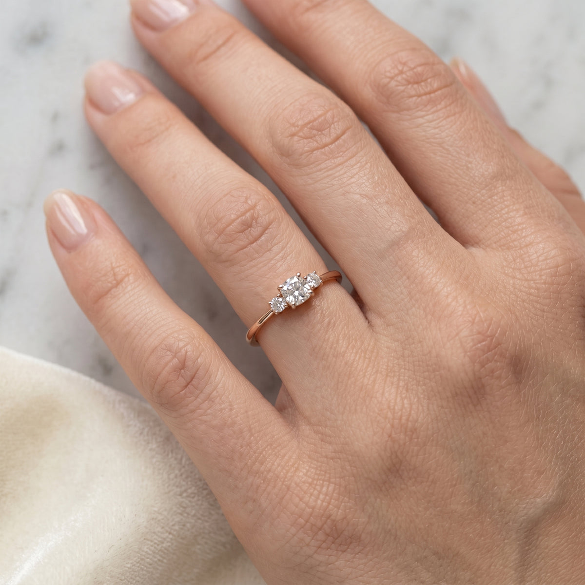 Cushion Cut Three Stone Engagement Ring with Round Sides — lifestyle