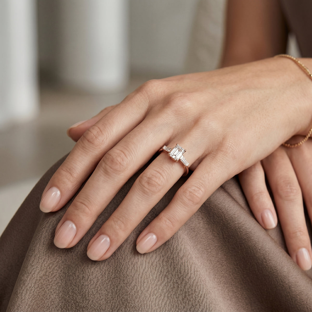 Emerald Cut Three Stone Engagement Ring with Tapered Baguette Sides — lifestyle