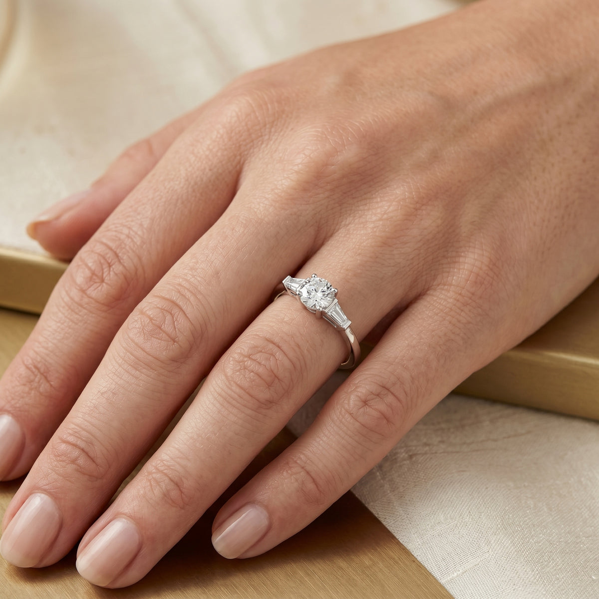 Round Diamond Three Stone Engagement Ring with Tapered Baguette Sides — lifestyle