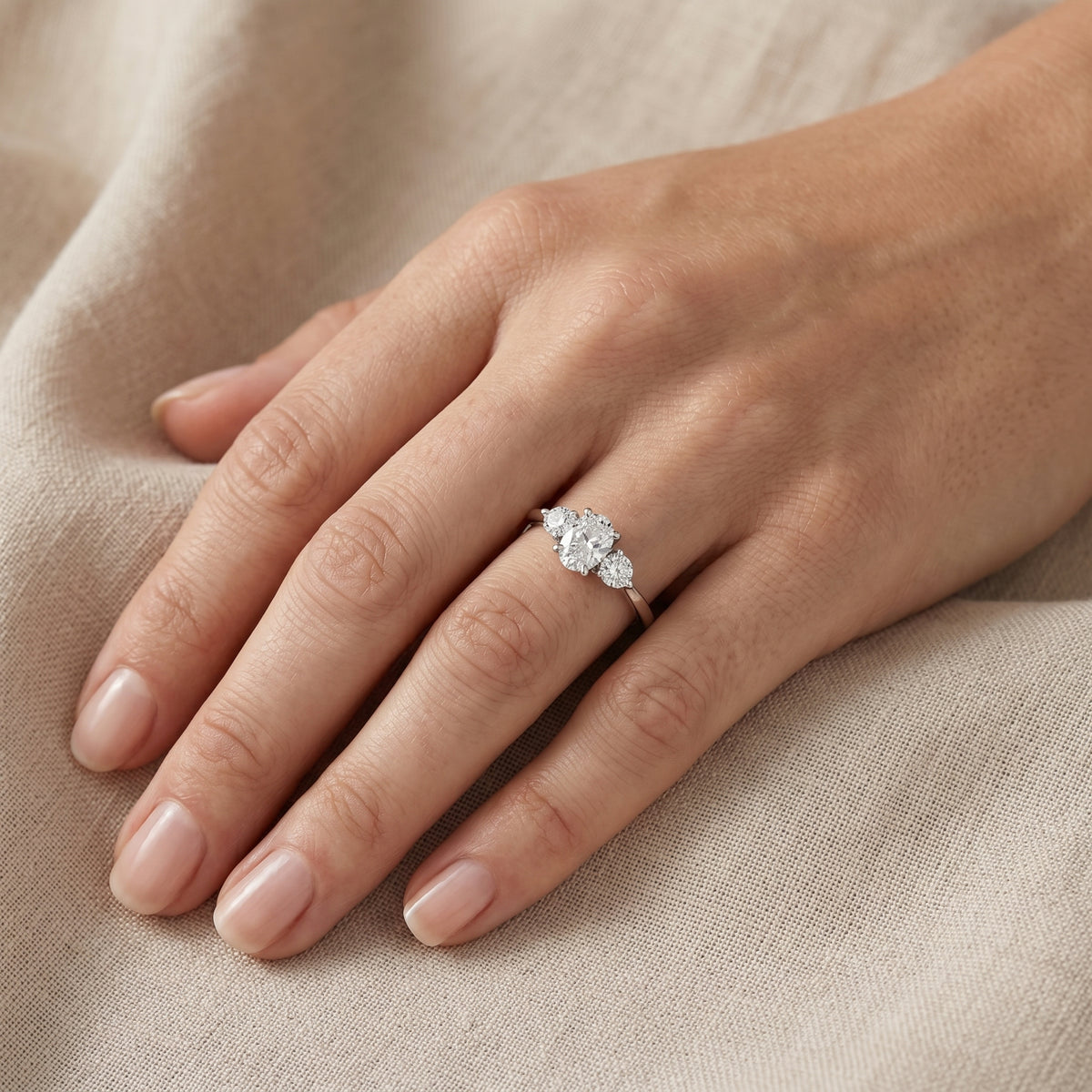 Oval Diamond Three Stone Engagement Ring with Round Sides — lifestyle