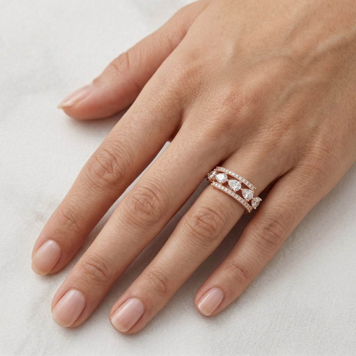 Signature Pear.                                  Pear and Round Diamond Band. — lifestyle