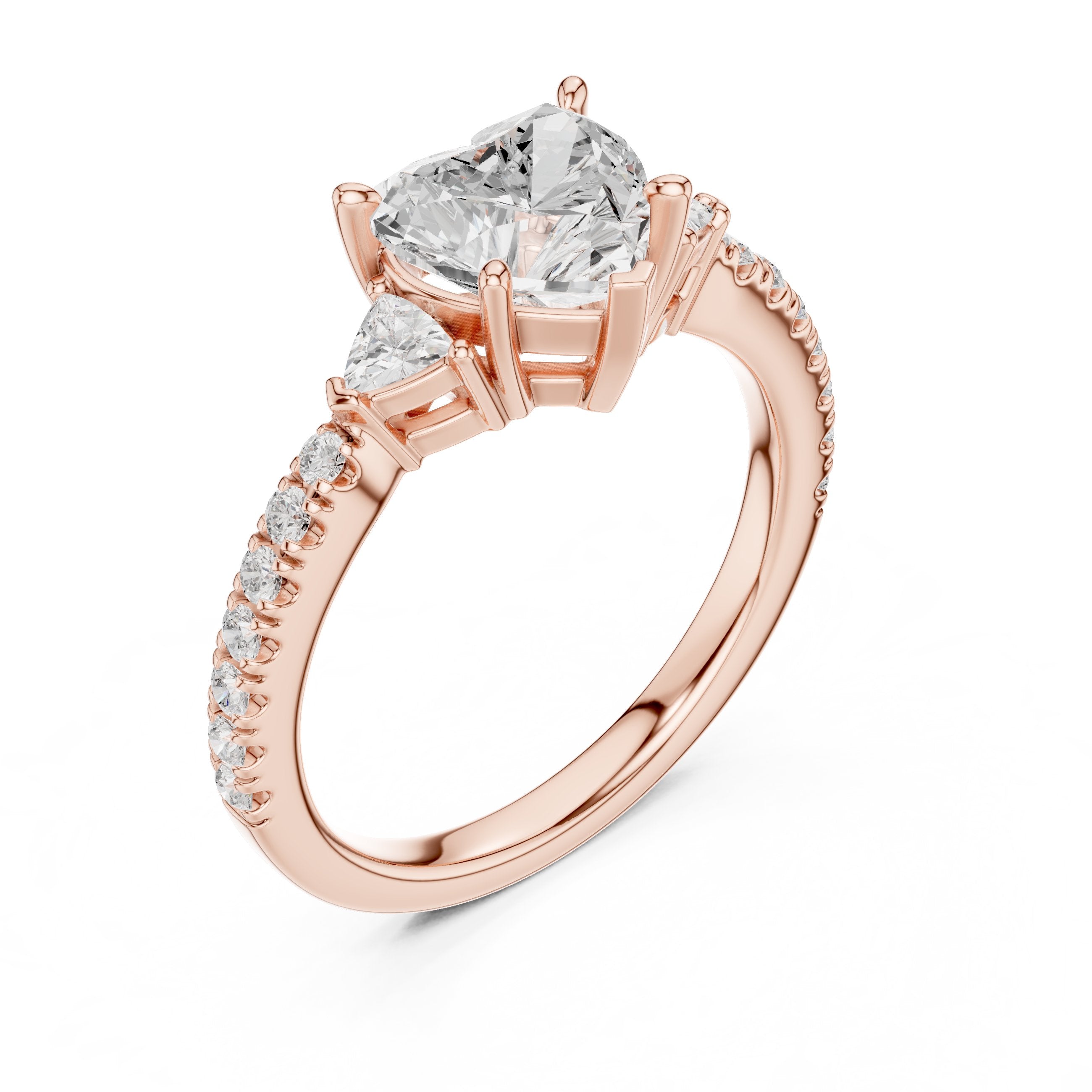 Heart Cut Three Stone Engagement Ring with Trilliant Sides and Pavé Band in Rose Gold - VYKA Diamonds