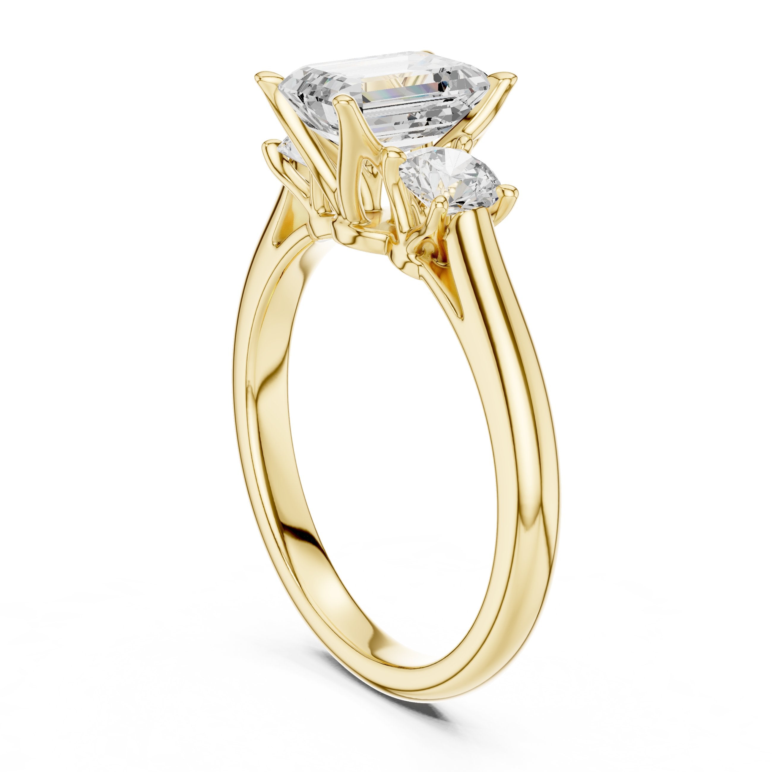 Emerald Cut Three Stone Engagement Ring with Round Sides in Yellow Gold - VYKA Diamonds