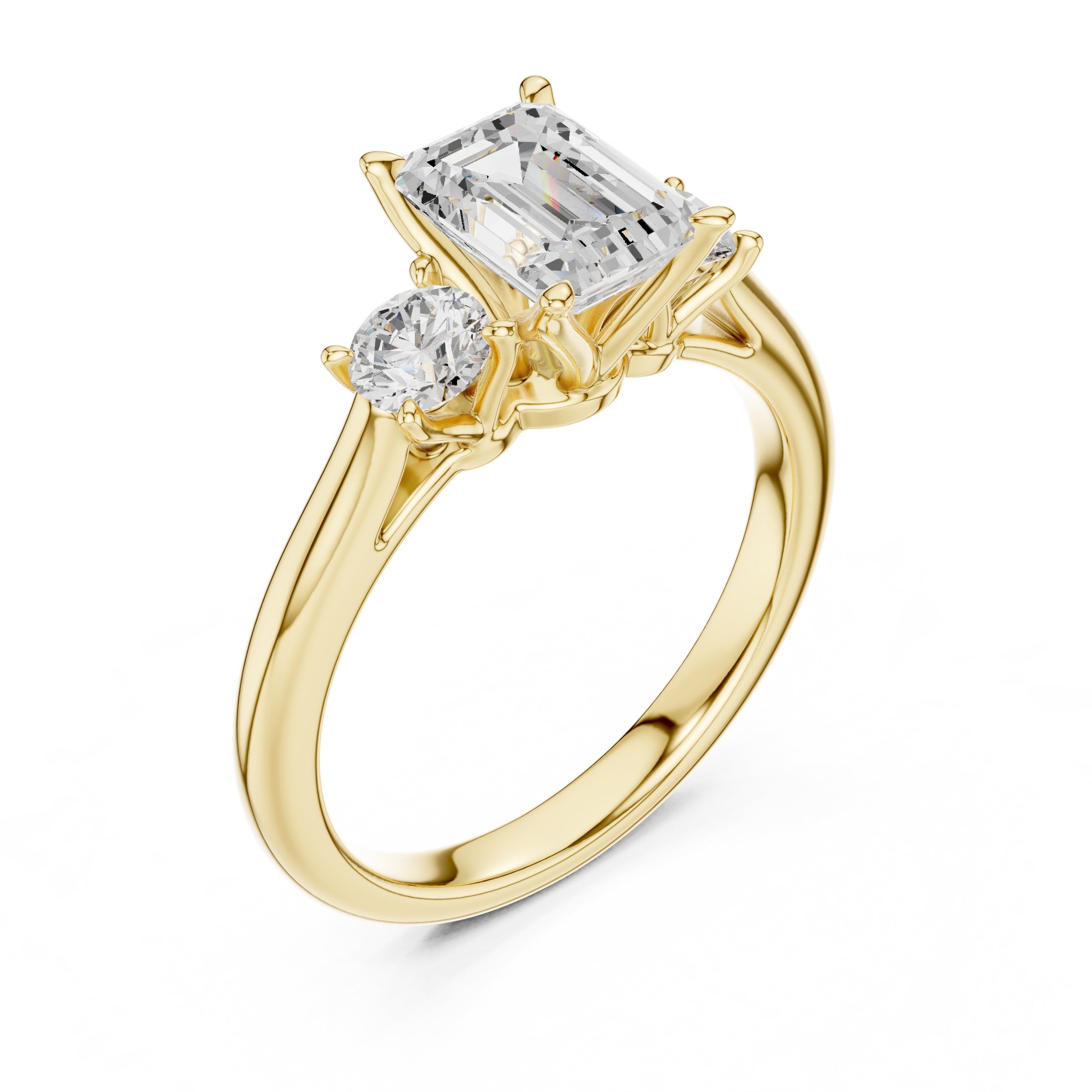 Emerald Cut Three Stone Engagement Ring with Round Sides in Yellow Gold - VYKA Diamonds
