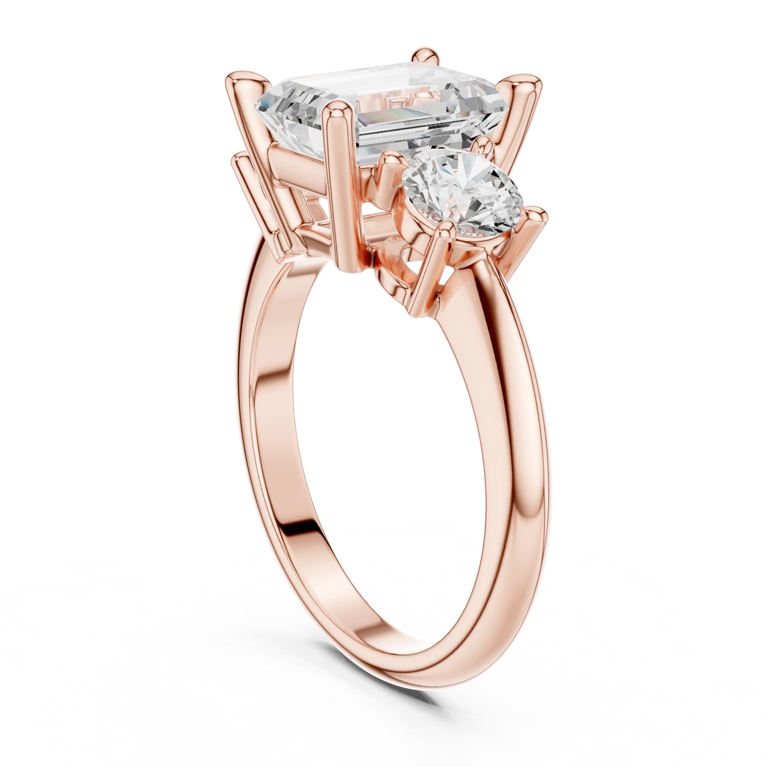 Emerald Cut Three Stone Engagement Ring with Round Sides in Rose Gold - VYKA Diamonds