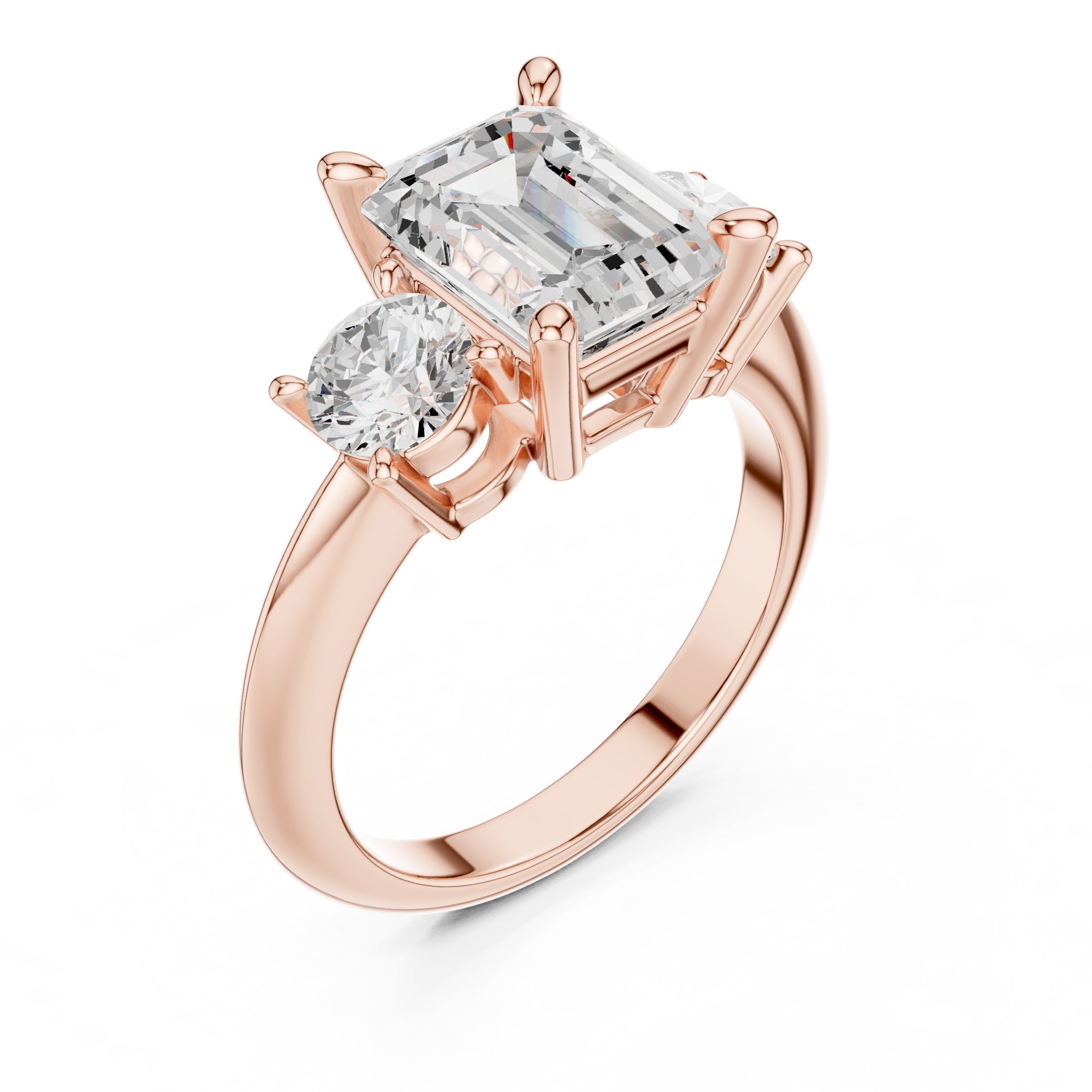 Emerald Cut Three Stone Engagement Ring with Round Sides in Rose Gold - VYKA Diamonds