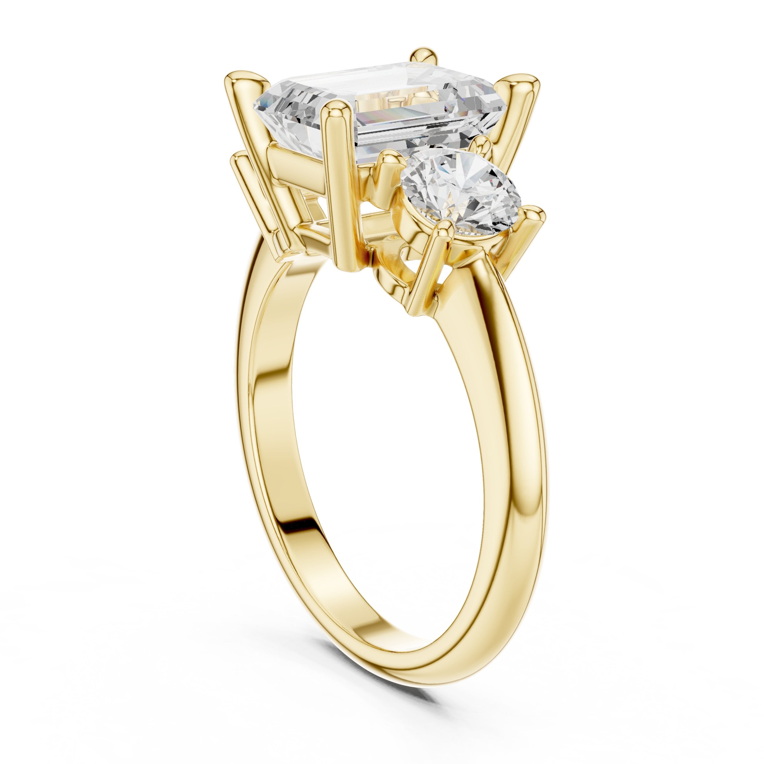 Emerald Cut Three Stone Engagement Ring with Round Sides in Yellow Gold - VYKA Diamonds