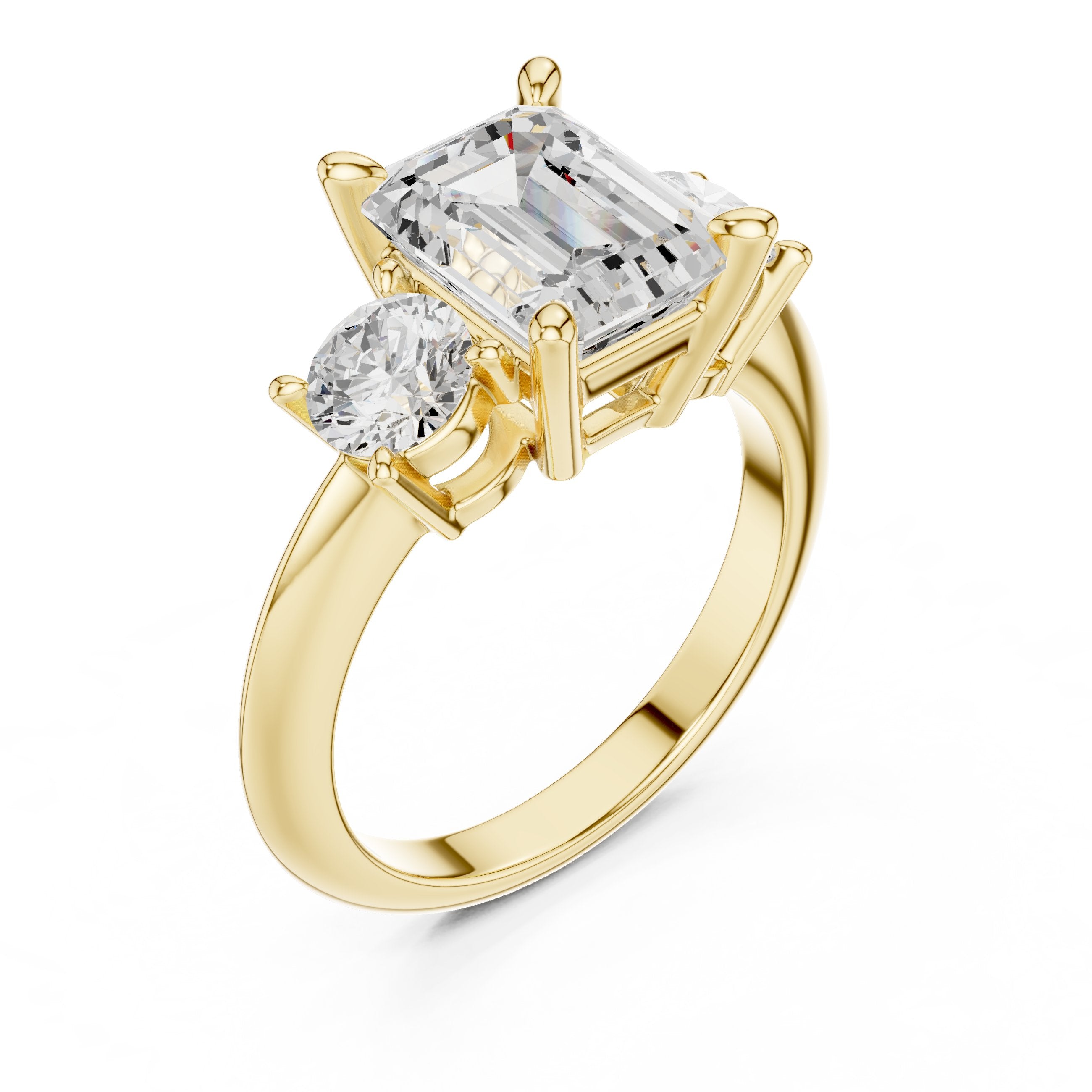 Emerald Cut Three Stone Engagement Ring with Round Sides in Yellow Gold - VYKA Diamonds