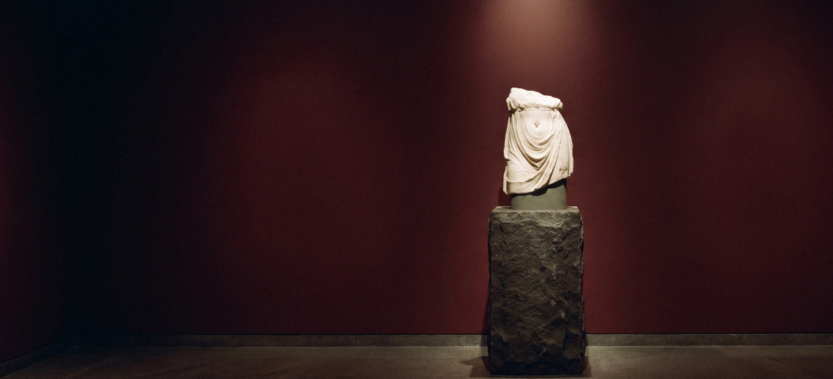 Centre by VYKA — a veiled marble waist on a stone plinth, a diamond at its centre